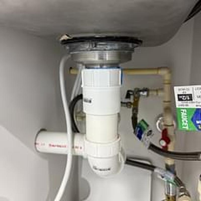 Basket strainer and PVC drain plumbing under sink