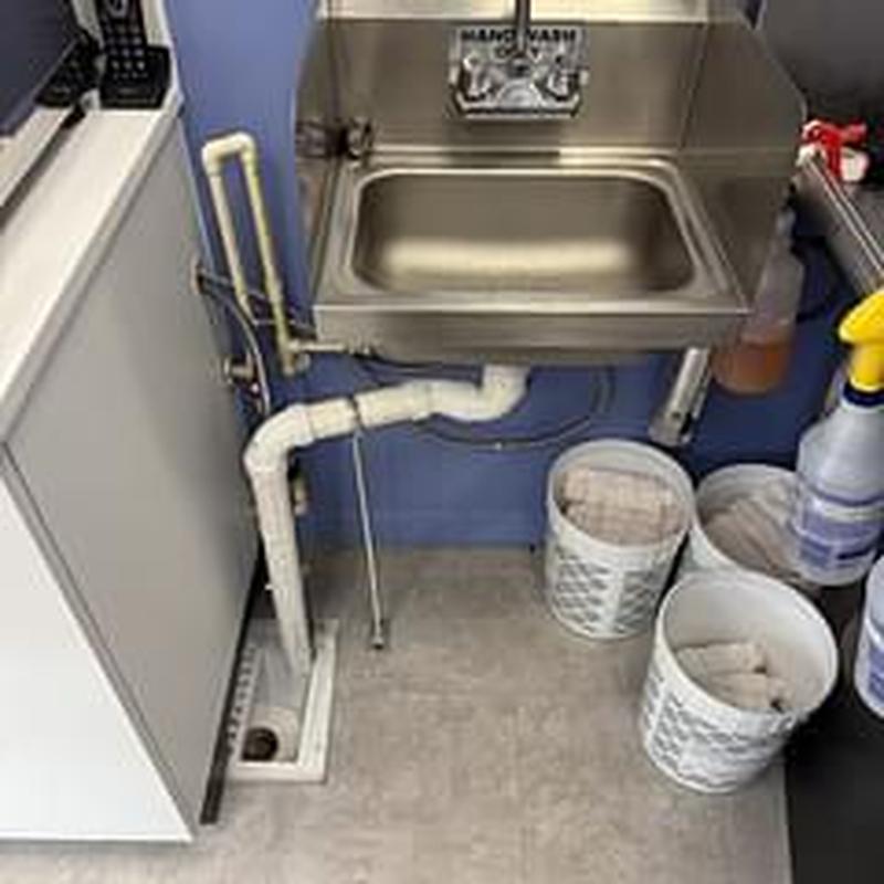 Stainless steel sink with replaced basket strainer and PVC drain