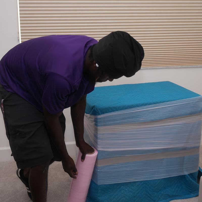 Furniture wrapped in moving blankets for protection