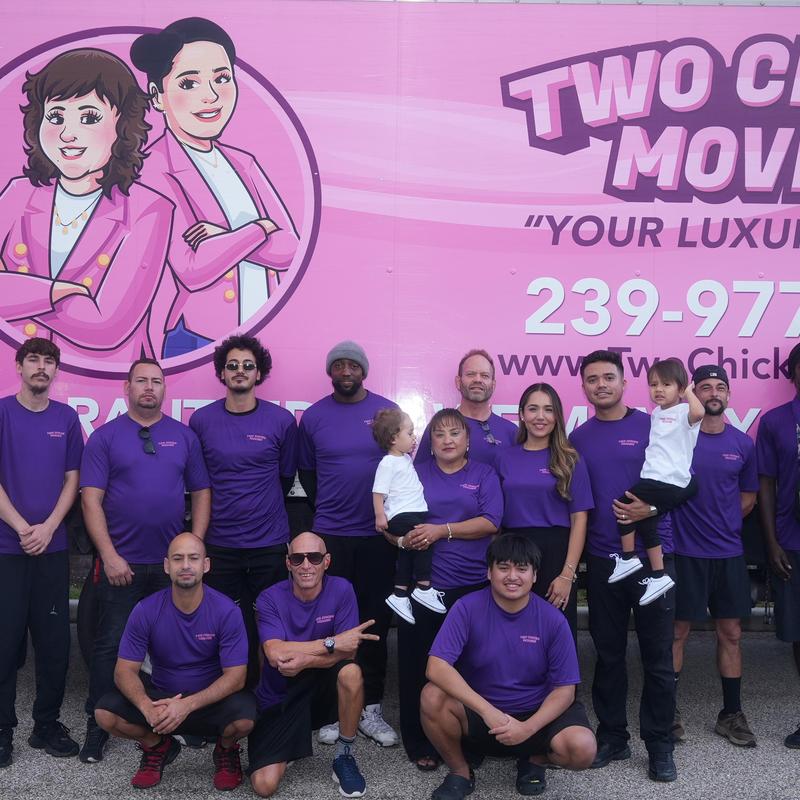 Local moving team in purple uniforms outside company truck