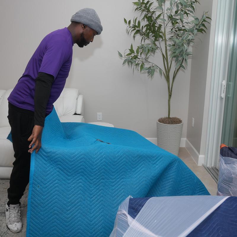 Sofa with moving blanket during local relocation