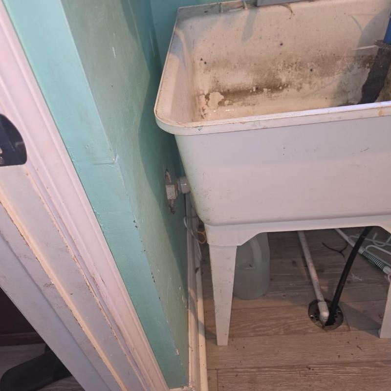 Laundry utility sink with water pipes and drain hole Laundry utility sink with water pipes and drain hole