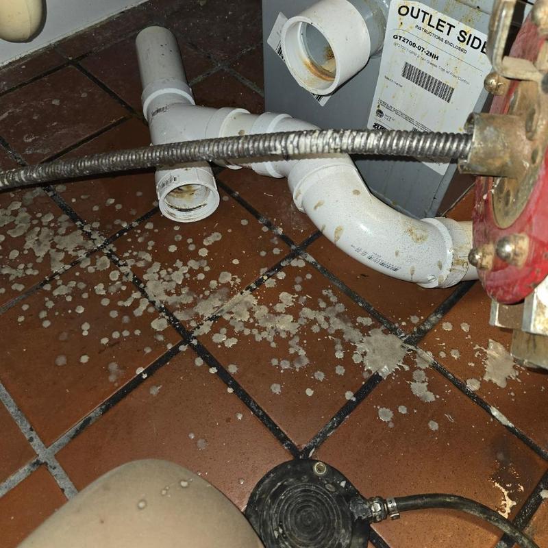 PVC main drain pipe under furnace with water stains PVC main drain pipe under furnace with water stains