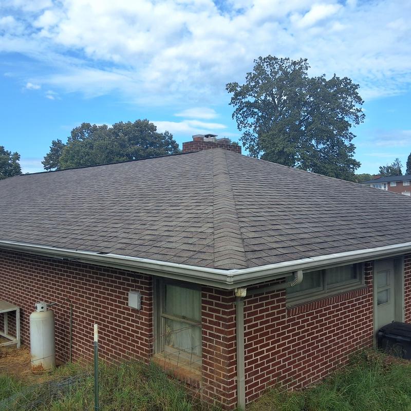 Asphalt shingle roof and gutter on home exterior