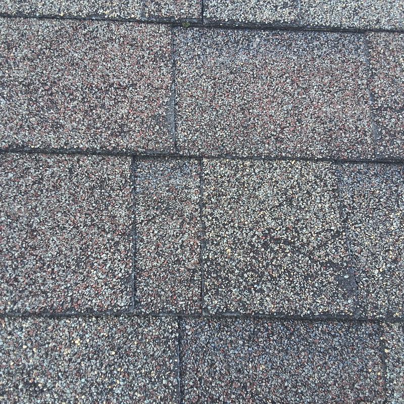 Asphalt roof shingles close-up showing granule texture
