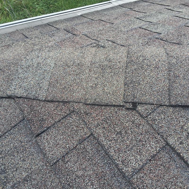 Asphalt shingle roof with gutter guard and grass edge