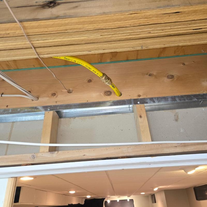 Gas line connector and meter valve installation above doorway Gas line connector and meter valve installation above doorway