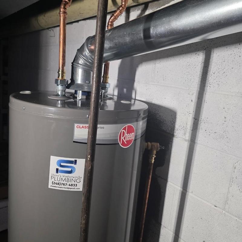 Natural gas water heater with vent and piping Natural gas water heater with vent and piping