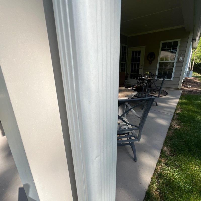 Vinyl porch column showing dent damage outdoors