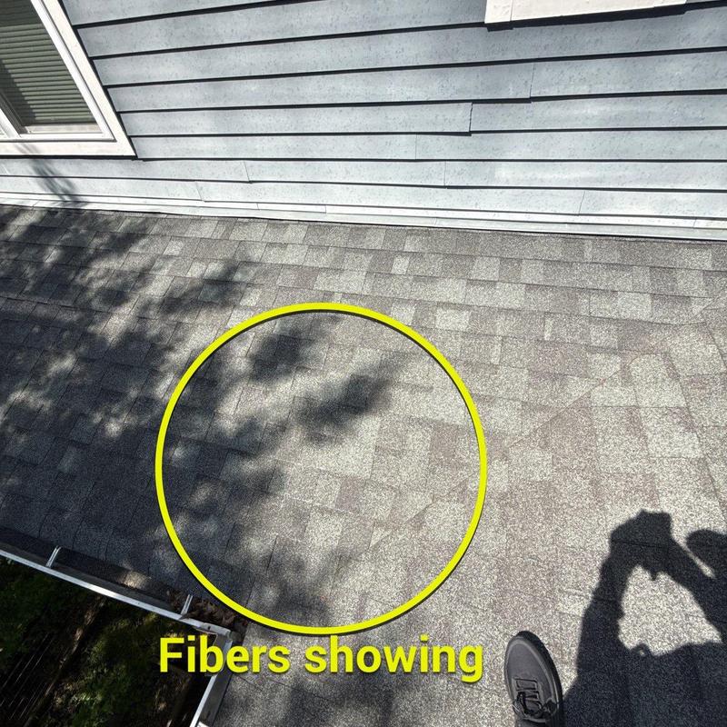 Roof shingles with fibers showing from hail damage