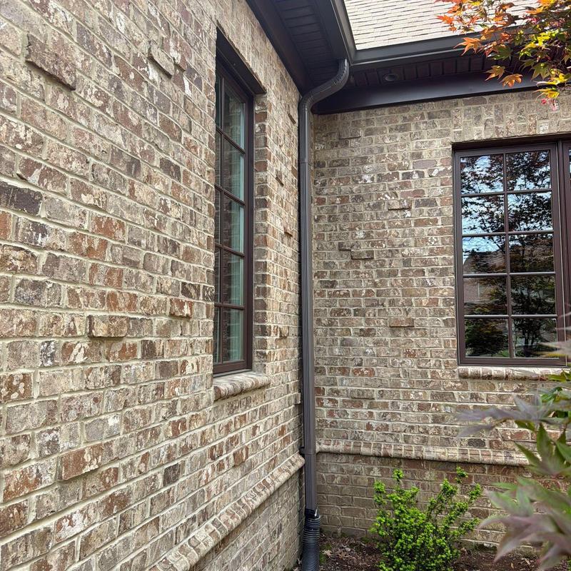 Gutter downspout and brick exterior corner installation