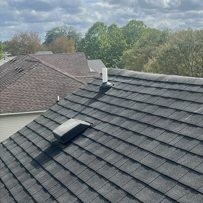 Shingle roof with vent and pipe on residential home