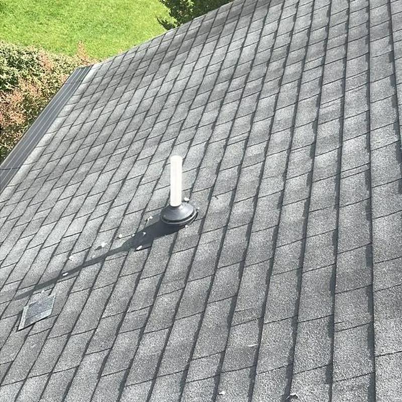 Shingle roof with plumbing vent and repaired shingles