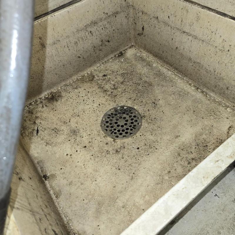Mop sink drain and basin with grime buildup Mop sink drain and basin with grime buildup