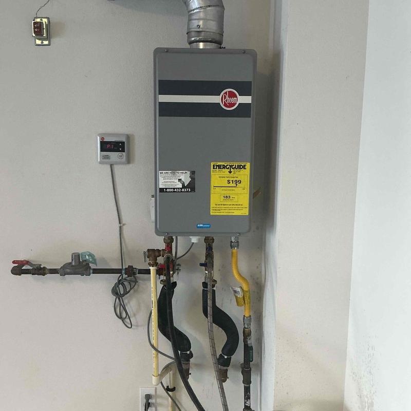 Tankless water heater with piping and vent