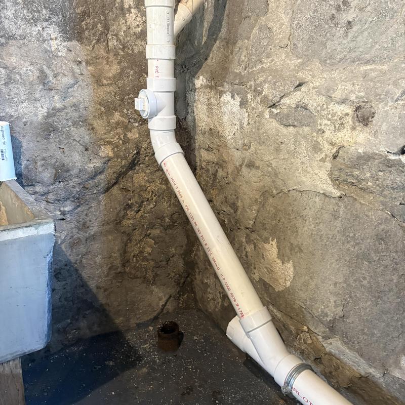 PVC basement drain line with new cast-iron waistline installation PVC basement drain line with new cast-iron waistline installation
