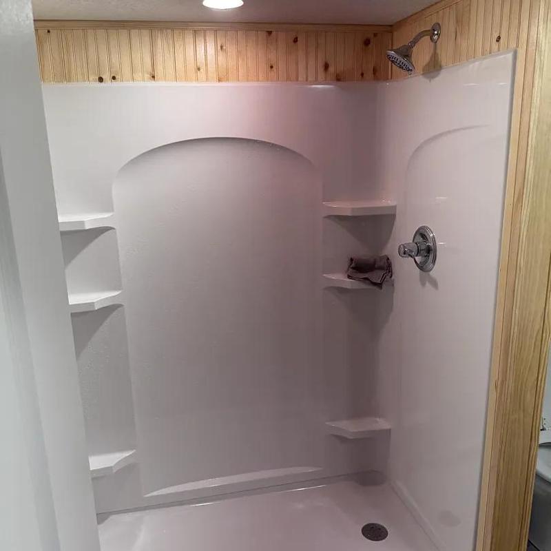 Shower enclosure with showerhead and shelves installed