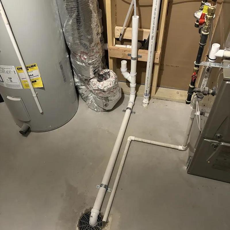 PVC drain pipe installation near water heater and furnace