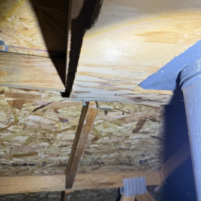 Chimney leak inspection under wooden roof structure
