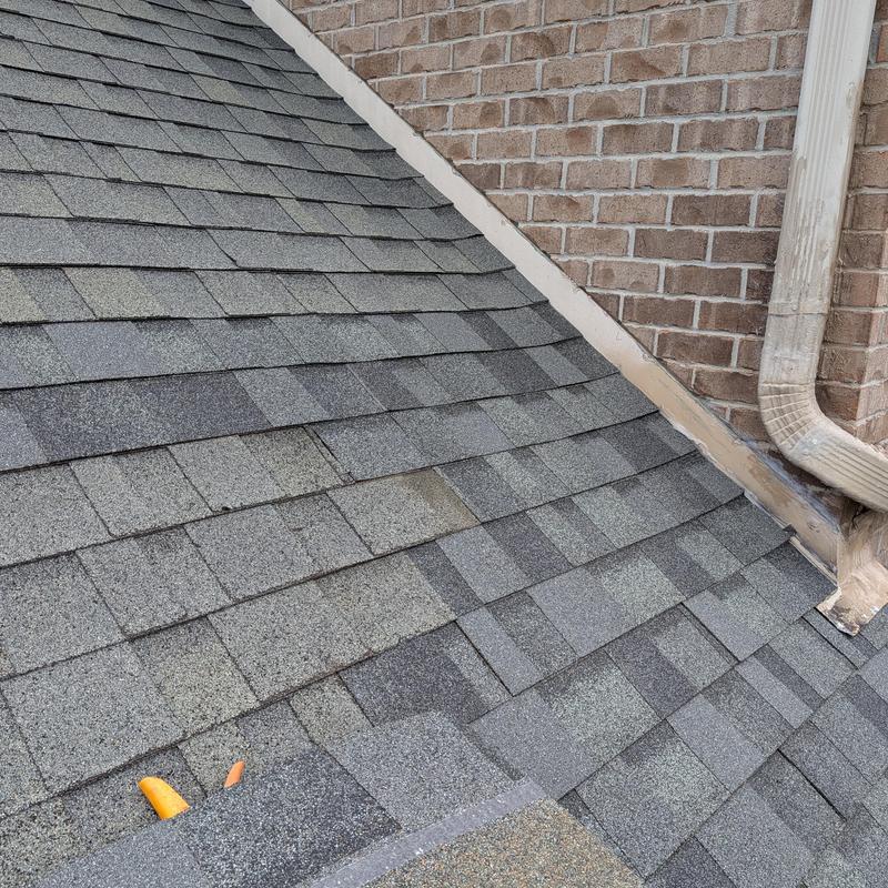 Roof shingles and flashing near wall leak repair in Madison