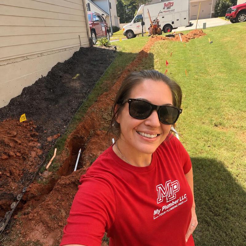 Water line trench excavation alongside house yard