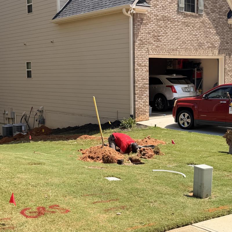 Water line excavation in residential yard repair
