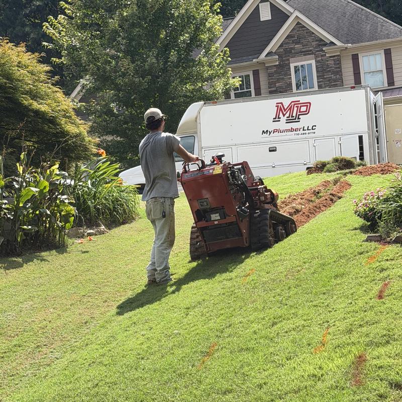 Water main line trench excavation on residential lawn