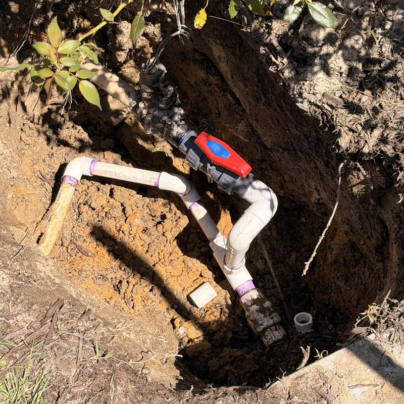 Main water line with irrigation shutoff valve in trench