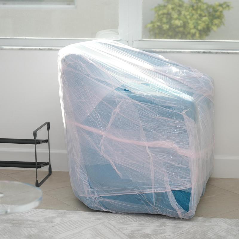 Upholstered armchair wrapped in protective plastic