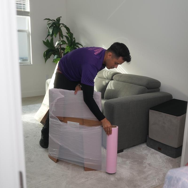 Furniture wrapping with protective plastic wrap during move