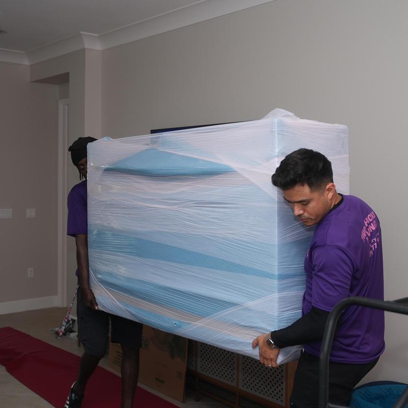 Wrapped couch being carried during local move in Florida