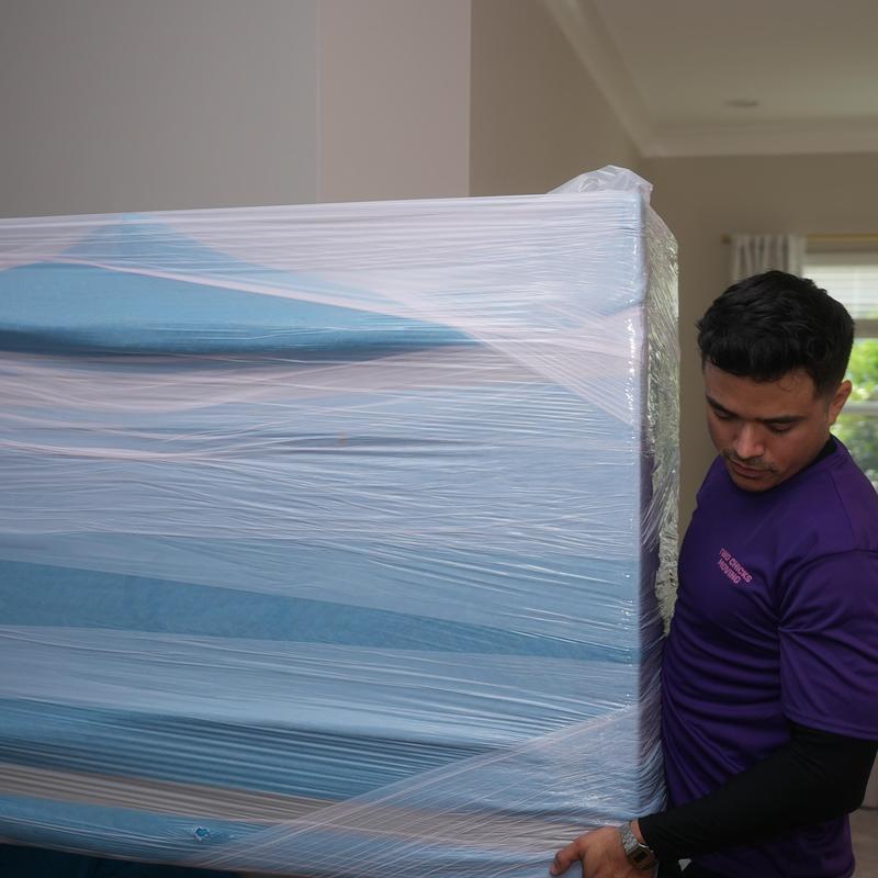 Wrapped mattress being carried during local move