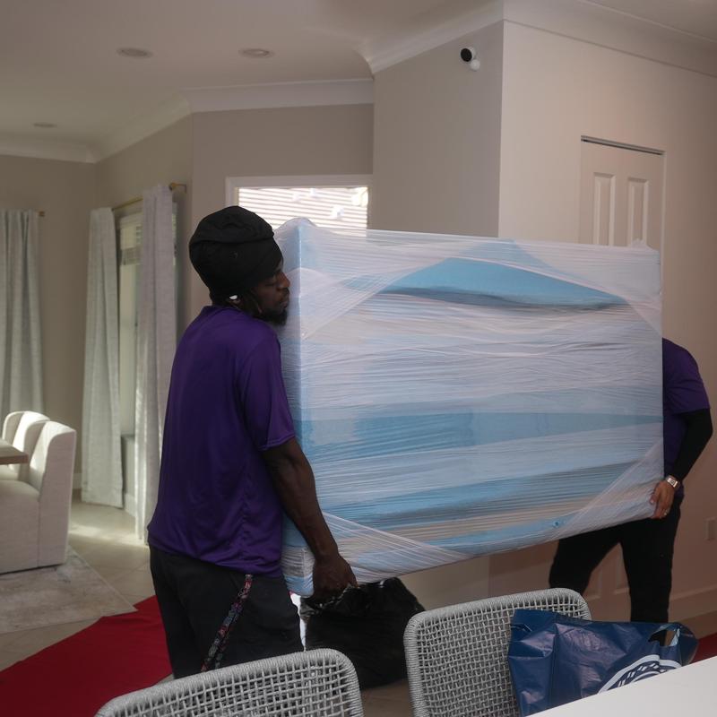 Wrapped sofa carrying during local move in Fort Myers, FL