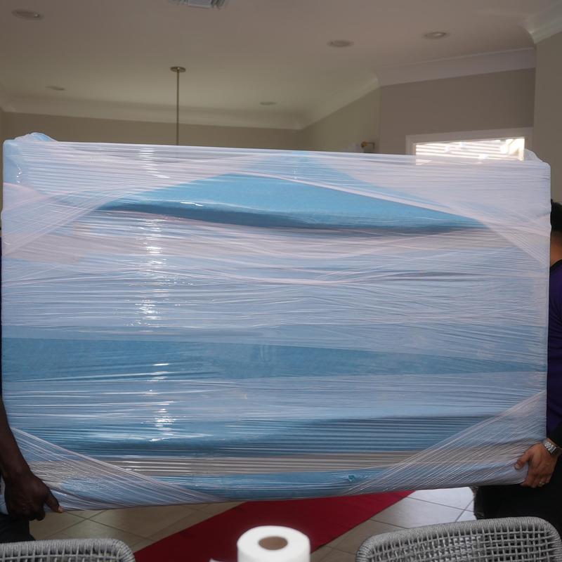 Foam mattress wrapped and carried for local moving