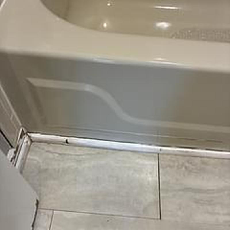 Bathtub edge with minor caulking in kids bathroom