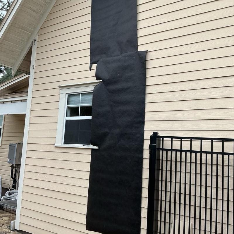 House siding with black weather barrier wrapping House siding with black weather barrier wrapping