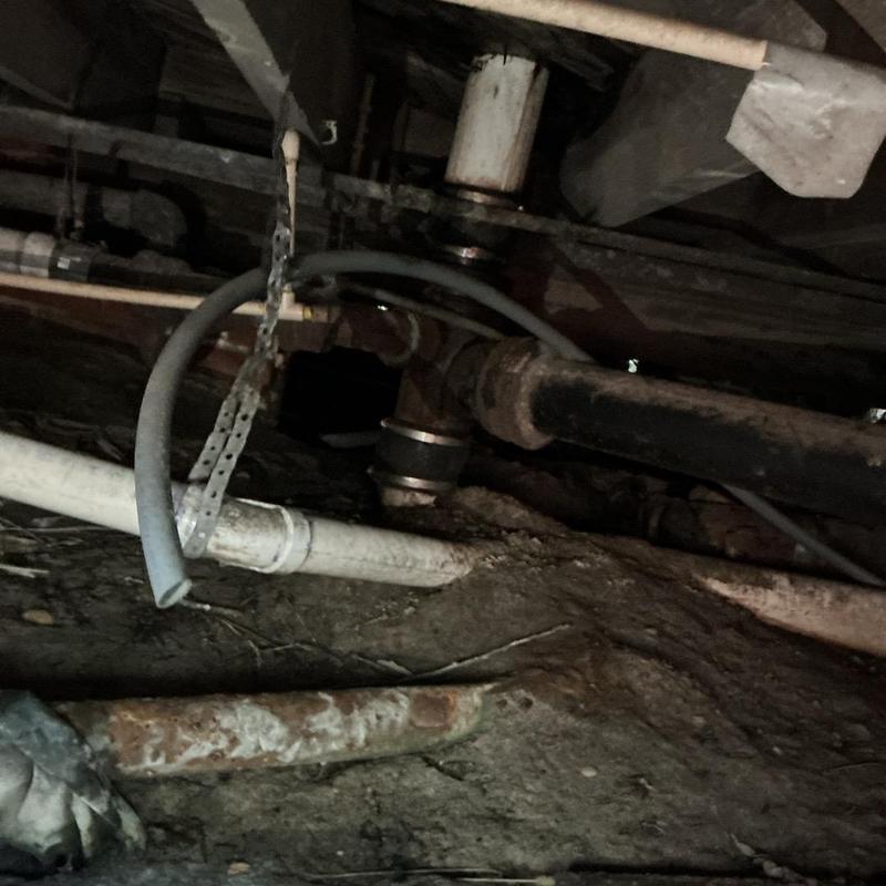 Toilet flange and PVC pipe in crawl space underfloor Toilet flange and PVC pipe in crawl space underfloor
