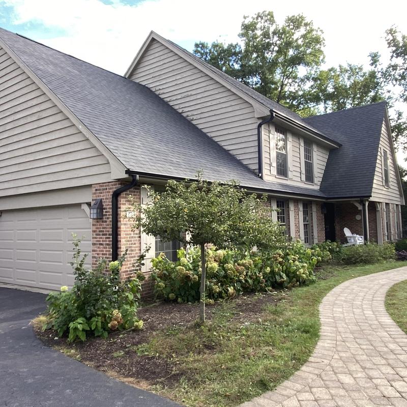 Atlas Impact Class 4 roof with gutter guards on house exterior