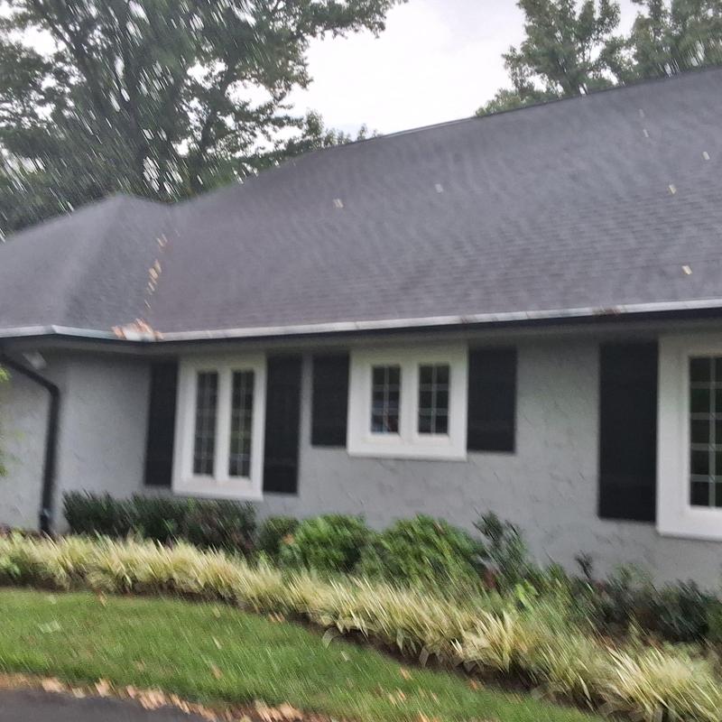 Asphalt shingle roof with visible damage and wear