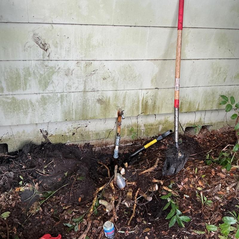 Water service line underground repair with tools and soil dug up Water service line underground repair with tools and soil dug up