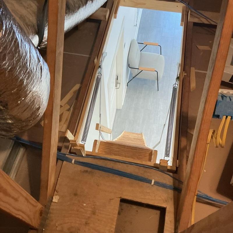 Attic ladder installation with wooden frame and springs Attic ladder installation with wooden frame and springs