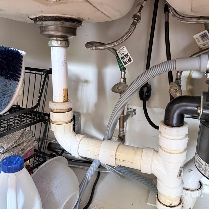 Kitchen sink drain pipes and faucet supply lines under sink Kitchen sink drain pipes and faucet supply lines under sink