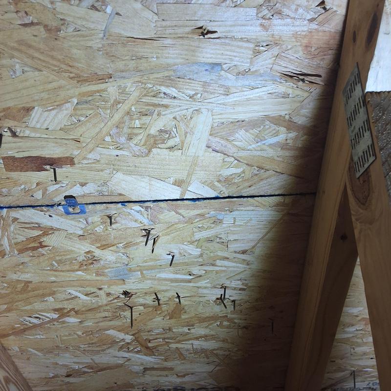 Oriented strand board roof sheathing with water stains Oriented strand board roof sheathing with water stains