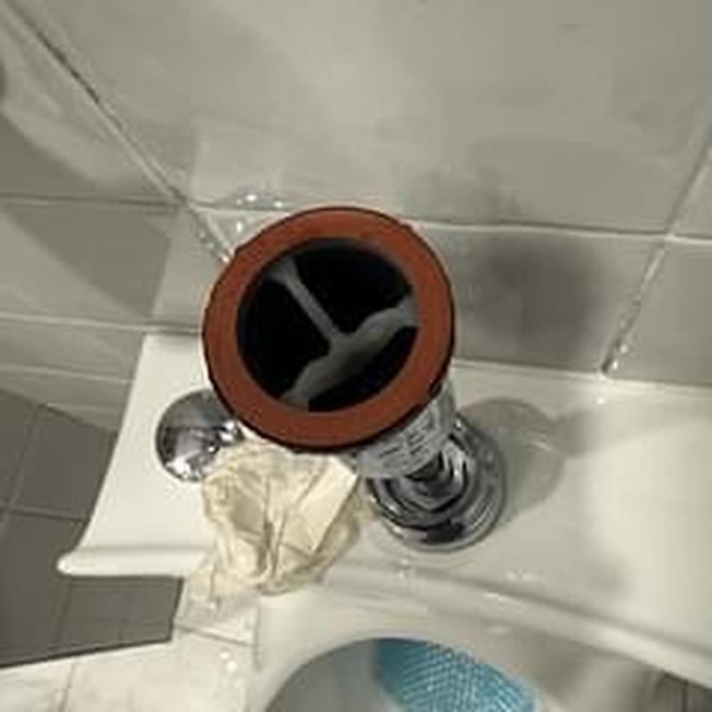 Flushometer valve on restroom urinal removed for replacement