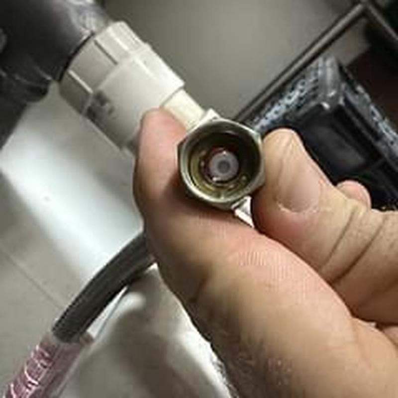 Flushometer valve assembly held before installation in restroom