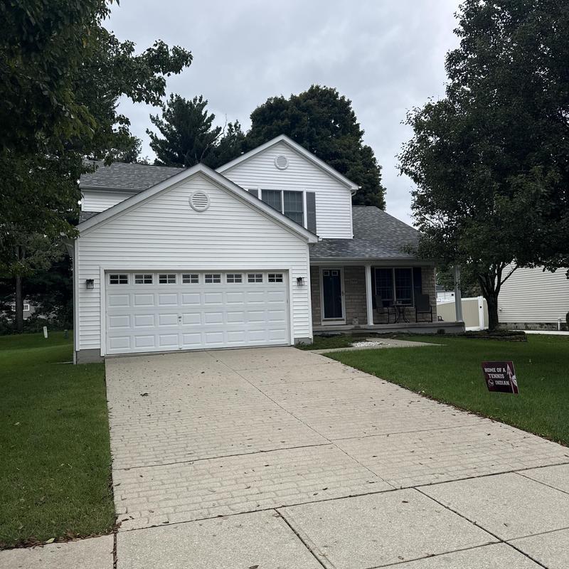 Roof shingles and siding inspection at two-story house
