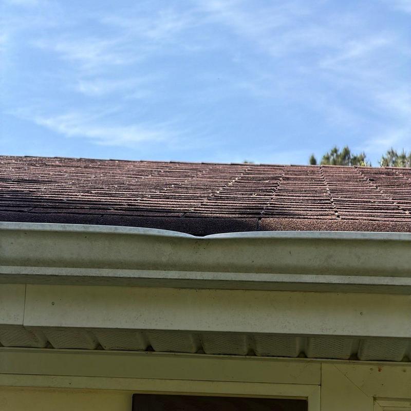 Roof gutter dent with shingle inspection above