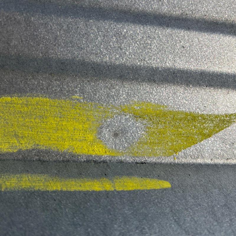 Metal roofing panel hail impact damage with yellow marking