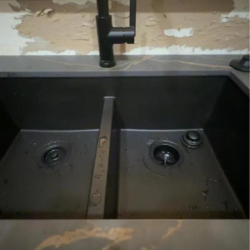 Kitchen sink with dual compartments and black faucet