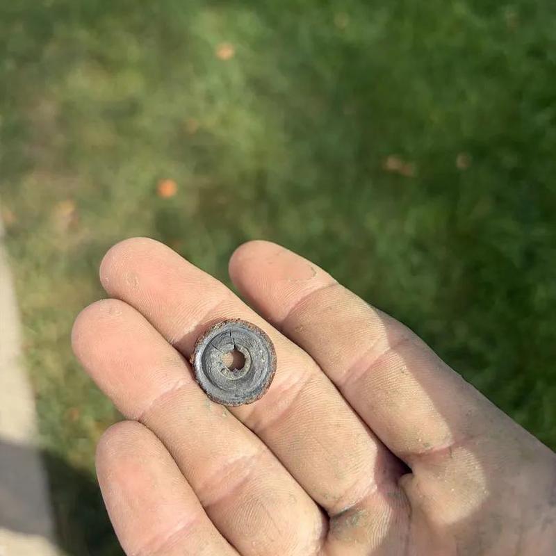 Spigot gasket held in hand after replacement outdoors